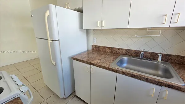 a kitchen with a stove and a window