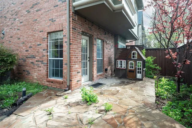 a view of brick house with yard and plants