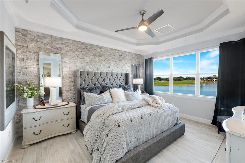 8783 Coastline Court, Unit 202 Naples, FL 34120 - Photo 22 of 49 a bedroom with a bed and a window