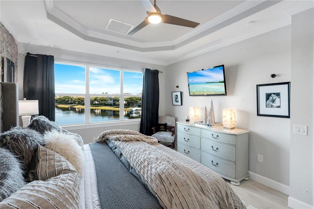 8783 Coastline Court, Unit 202 Naples, FL 34120 - Photo 23 of 49 a large bedroom with a large bed and a large window