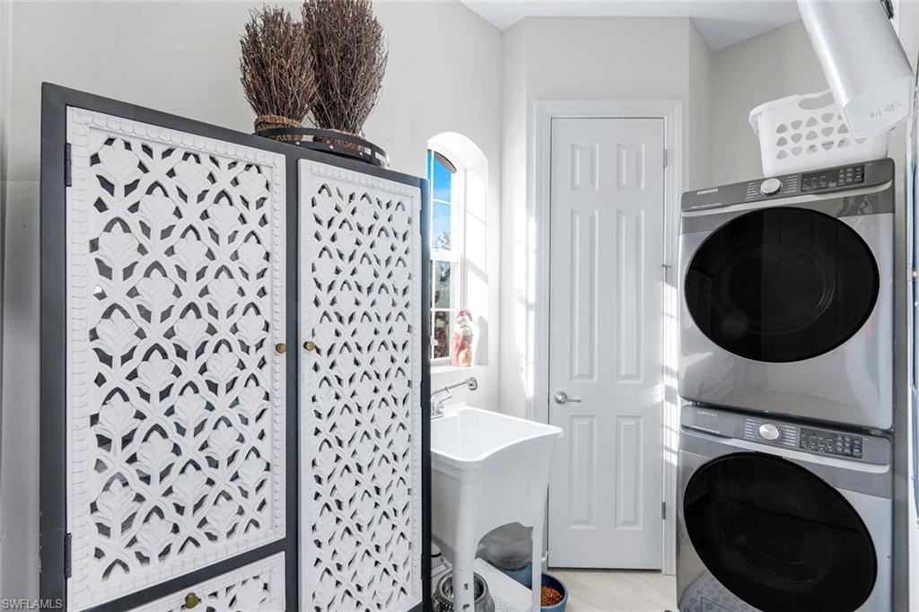 8783 Coastline Court, Unit 202 Naples, FL 34120 - Photo 31 of 49 a view of a hallway with washer and dryer