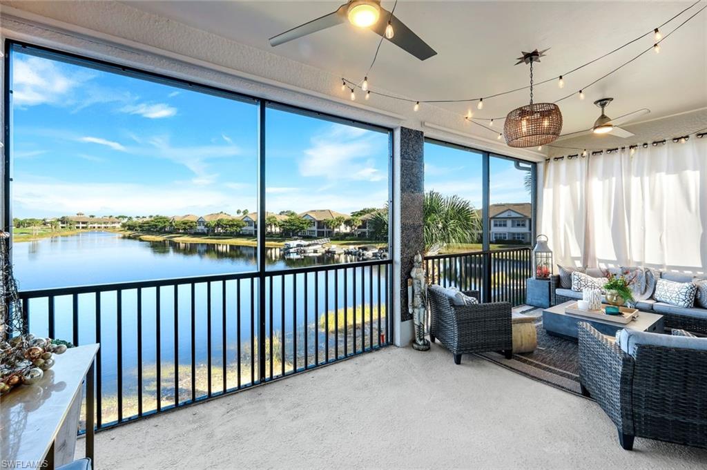 8783 Coastline Court, Unit 202 Naples, FL 34120 - Photo 33 of 49 a view of a living room and floor to ceiling window or chandelier
