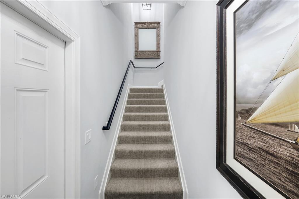 8783 Coastline Court, Unit 202 Naples, FL 34120 - Photo 6 of 49 a view of a hallway with wooden floor and entryway