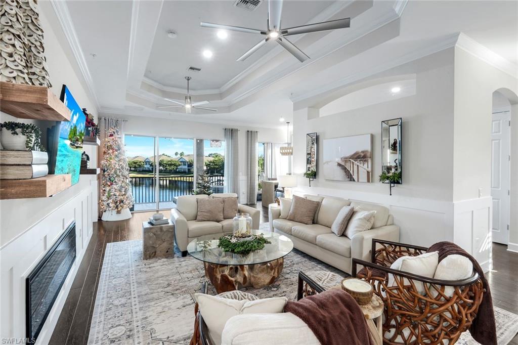 8783 Coastline Court, Unit 202 Naples, FL 34120 - Photo 7 of 49 a living room with furniture fireplace and a large window