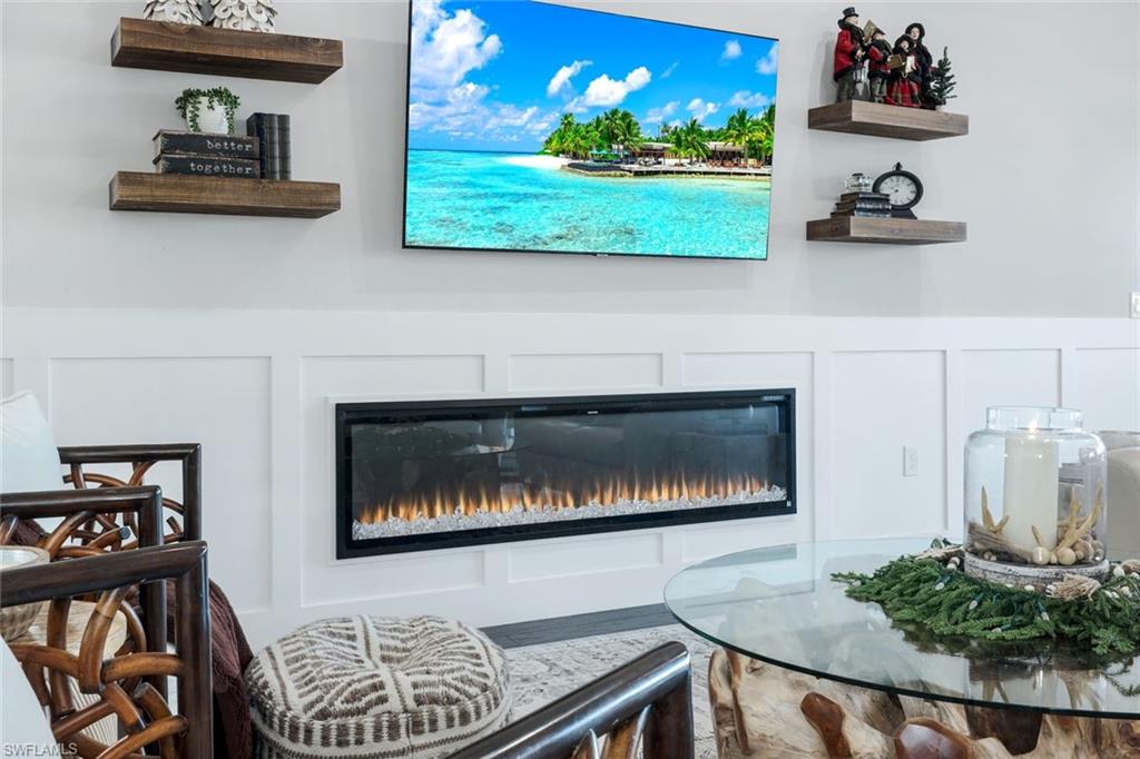 8783 Coastline Court, Unit 202 Naples, FL 34120 - Photo 9 of 49 a kitchen with a stove and cabinets