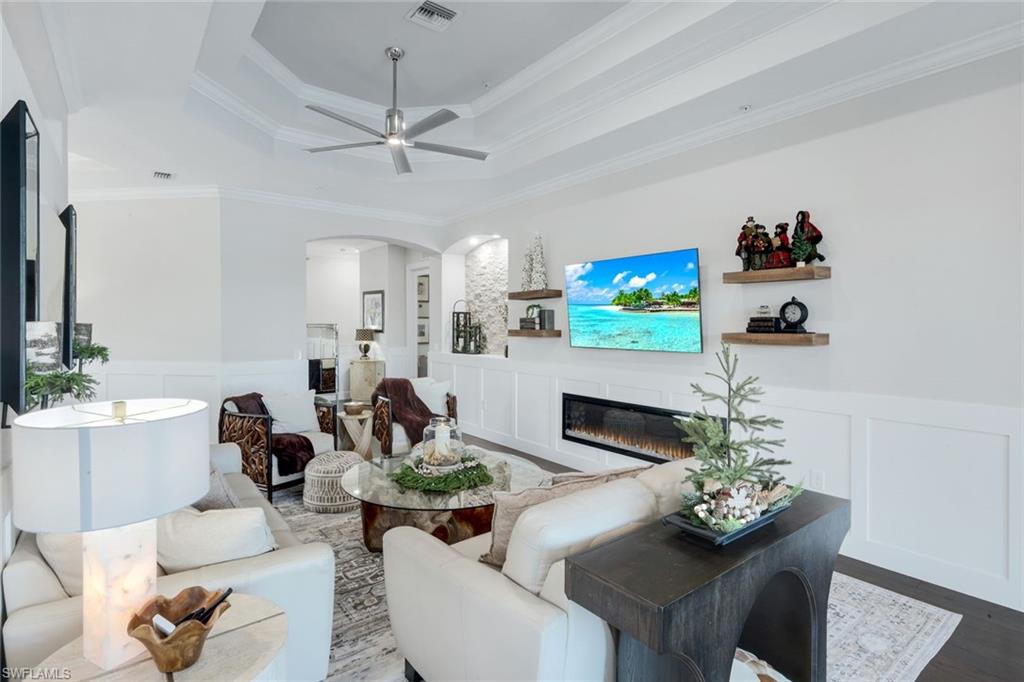 8783 Coastline Court, Unit 202 Naples, FL 34120 - Photo 10 of 49 a living room with furniture and a fireplace