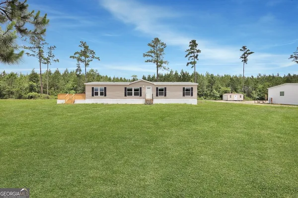 a view of a house with a big yard