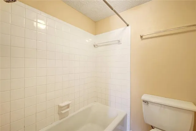 a bathroom with a shower and a toilet