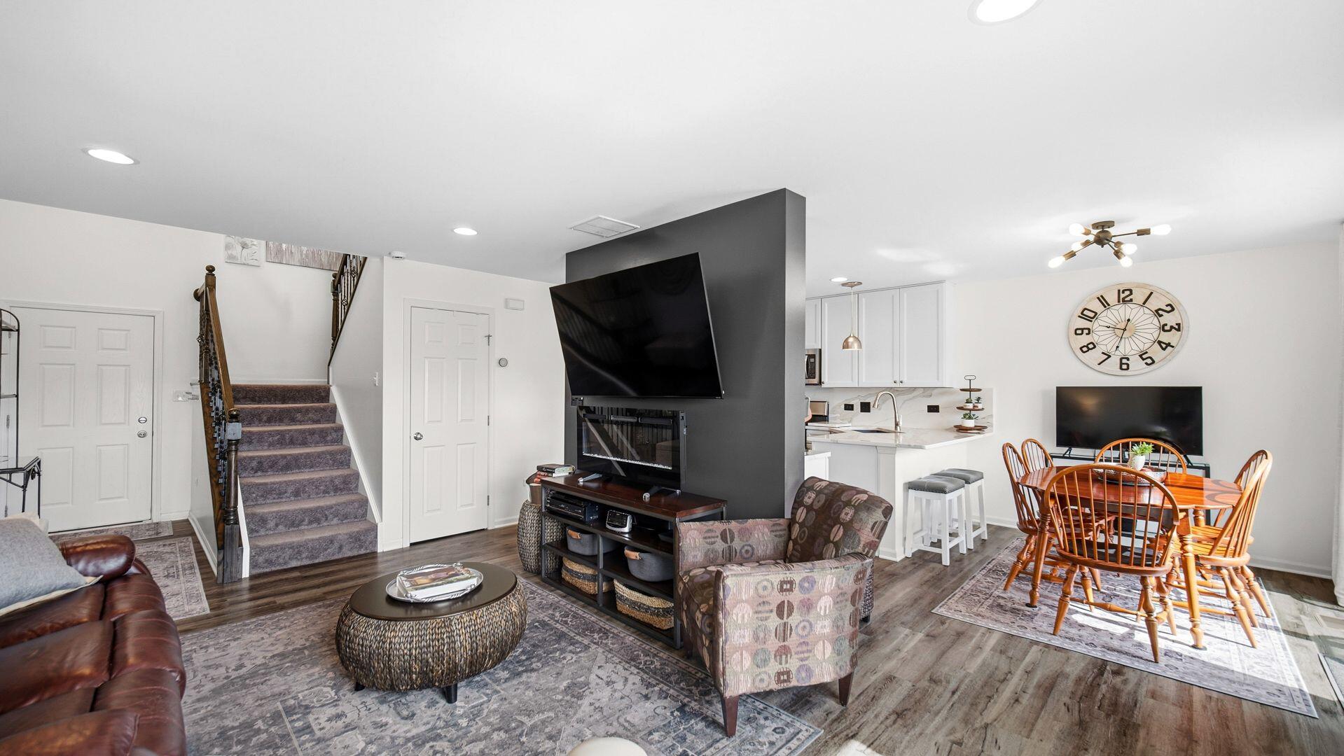 11175 Vermont Circle Crown Point, IN 46307 - Photo 4 of 22 a living room with furniture a fireplace and a flat screen tv