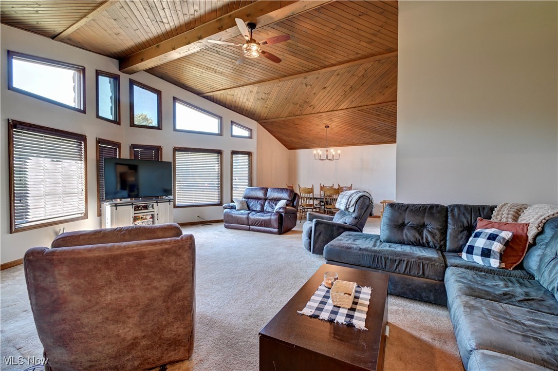 5747 Middle Run Road Dover, OH 44622 - Photo 11 of 30 Living room with high vaulted ceiling, carpet floors, a ceiling fan, a wooden ceiling with exposed beams, and a chandelier