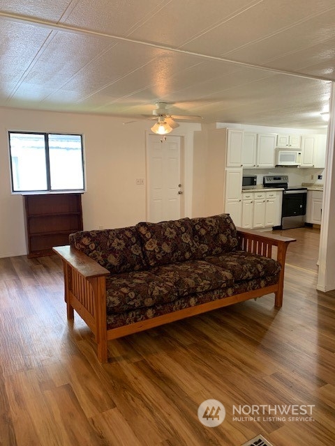 6800 North Enterprise Road, Unit 24 Ferndale, WA 98248 - Photo 3 of 18 a living room with hard wood floors and a kitchen