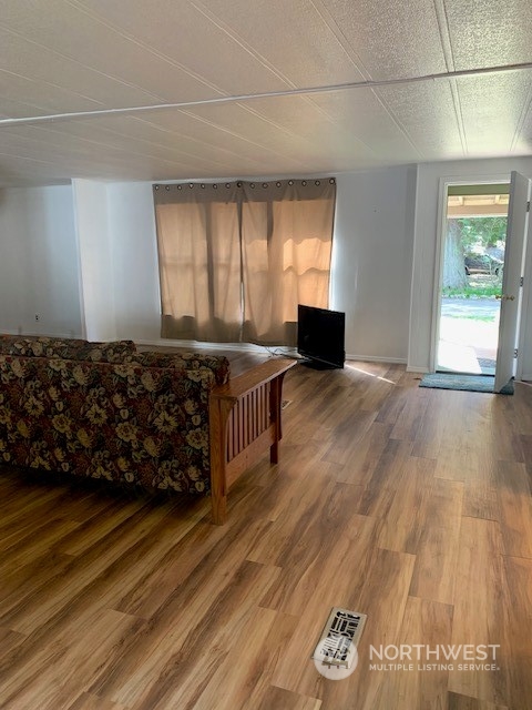 6800 North Enterprise Road, Unit 24 Ferndale, WA 98248 - Photo 5 of 18 a living room with a couch wooden floor and a window