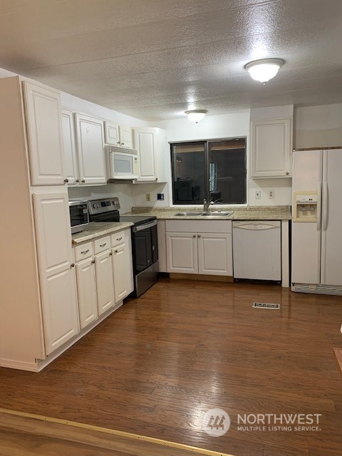 6800 North Enterprise Road, Unit 24 Ferndale, WA 98248 - Photo 6 of 18 a large white kitchen with cabinets