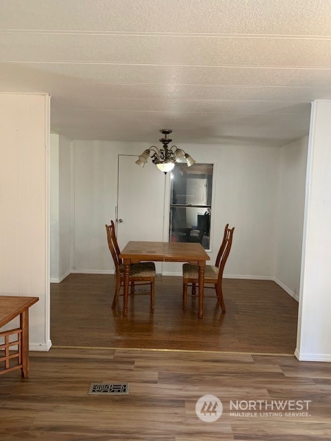 6800 North Enterprise Road, Unit 24 Ferndale, WA 98248 - Photo 7 of 18 a view of a dining room with furniture and wooden floor
