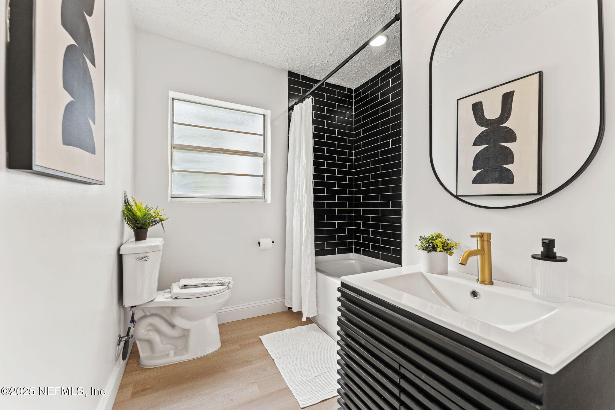 1436 Forest Hills Road Jacksonville, FL 32208 - Photo 18 of 27 a bathroom with a sink a toilet and a mirror