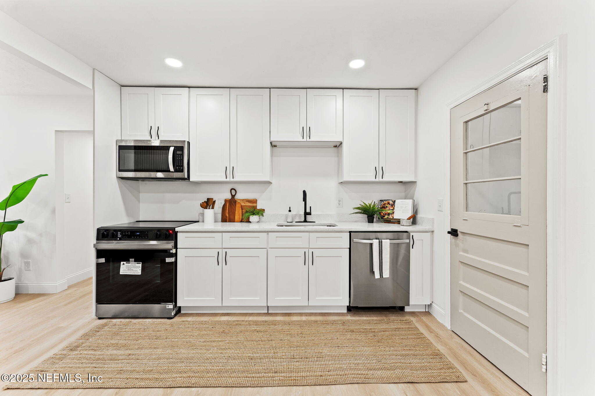1436 Forest Hills Road Jacksonville, FL 32208 - Photo 8 of 27 a kitchen with a sink cabinets and stainless steel appliances