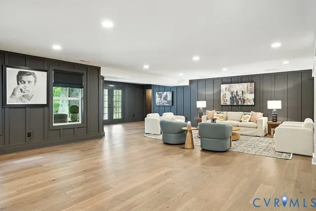 a living room with furniture and view of kitchen