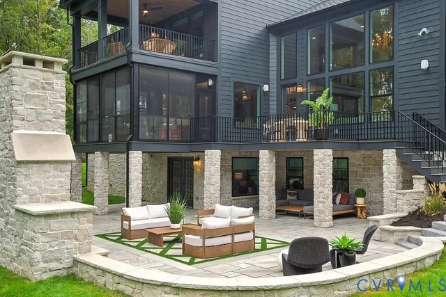 a view of a patio with couches table and chairs and garden view