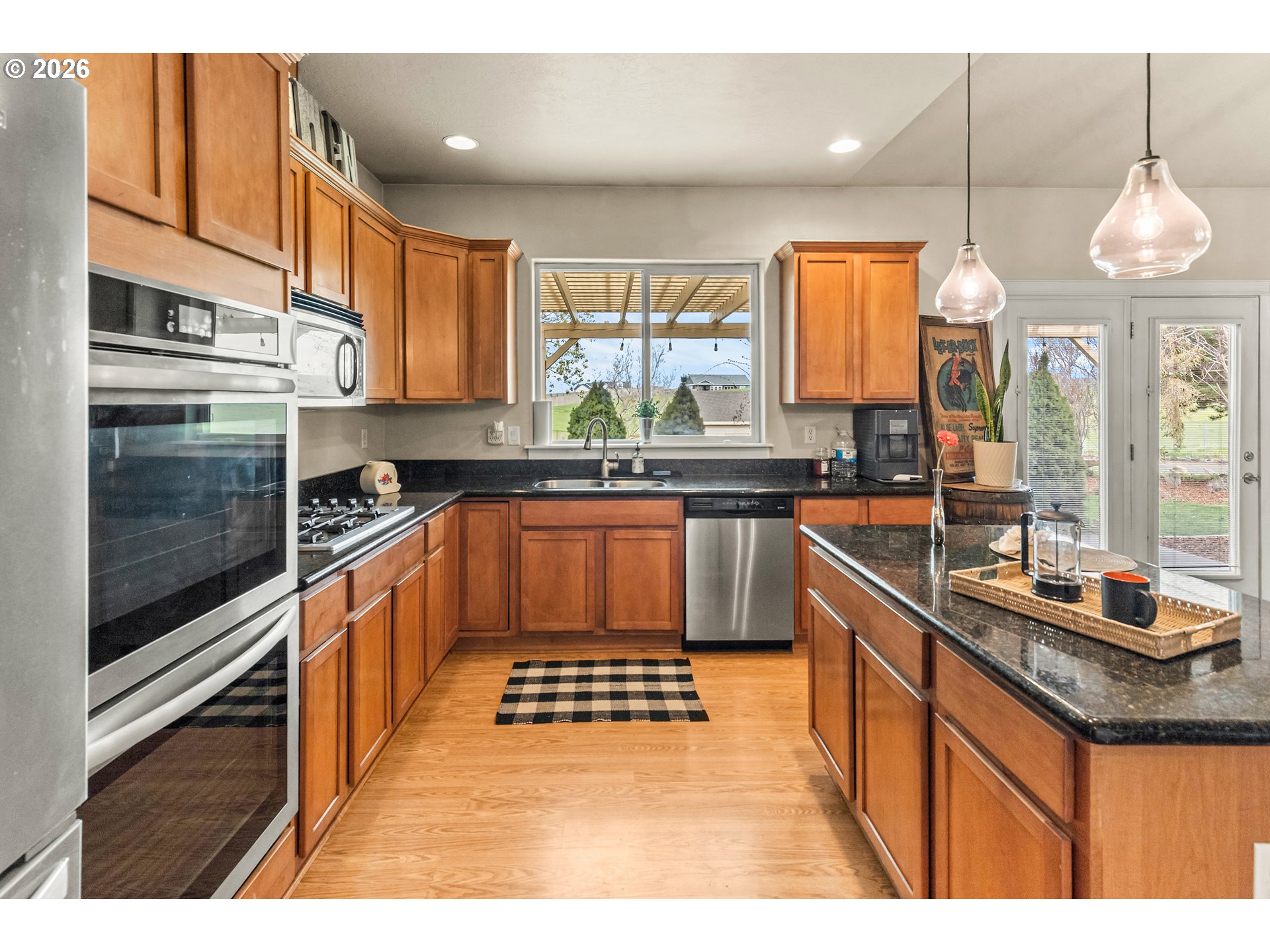 77286 Joyce Way Echo, OR 97826 - Photo 13 of 41 a kitchen with granite countertop stainless steel appliances a sink a counter space and a window