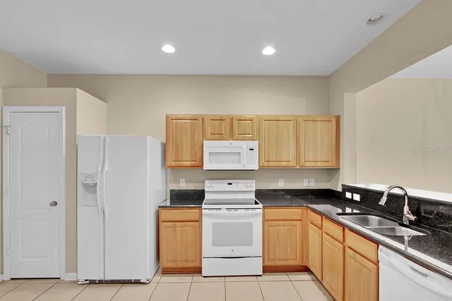 a kitchen that has a sink and a stove in it