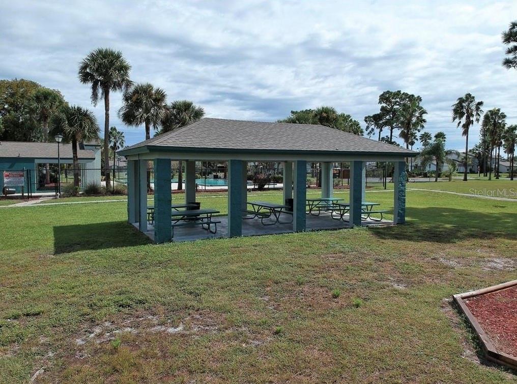 3216 Hempstead Avenue Kissimmee, FL 34741 - Photo 13 of 13 a view of a house next to a yard with big trees