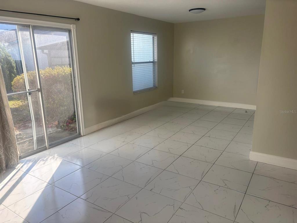 3216 Hempstead Avenue Kissimmee, FL 34741 - Photo 2 of 13 an empty room with windows