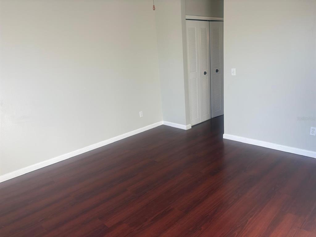 3216 Hempstead Avenue Kissimmee, FL 34741 - Photo 6 of 13 a view of an empty room with wooden floor
