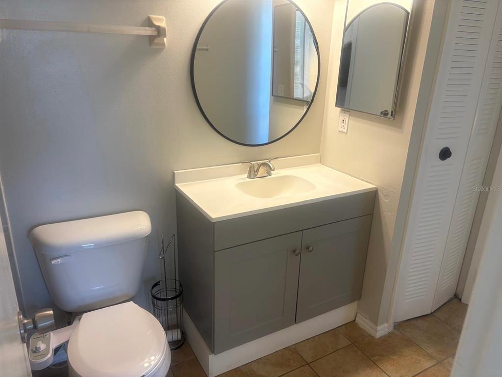 3216 Hempstead Avenue Kissimmee, FL 34741 - Photo 8 of 13 a bathroom with a toilet sink and mirror