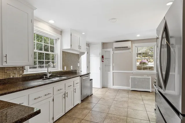 a kitchen with stainless steel appliances granite countertop a stove top oven a sink dishwasher a refrigerator and a oven