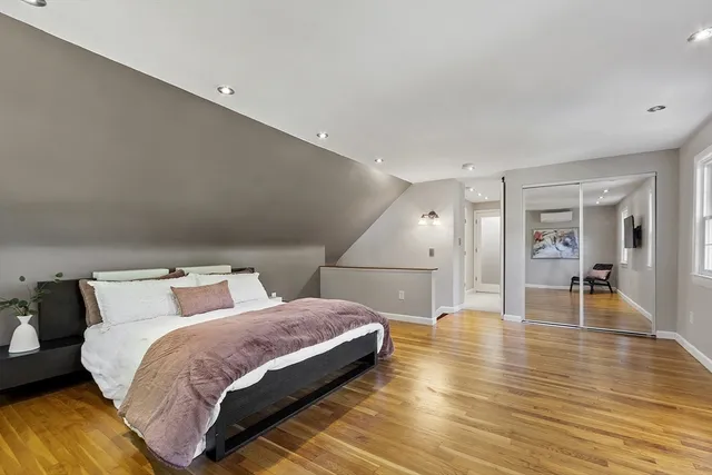 a bedroom with a bed and a painting on the wall