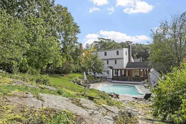 an aerial view of a house with a yard and mountain