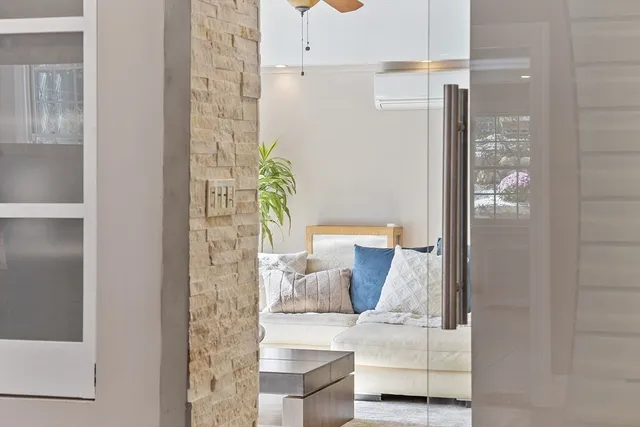 a living room with furniture a flat screen tv and a table