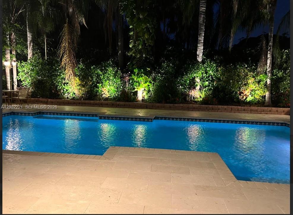 9941 Southwest 143rd Street Miami, FL 33176 - Photo 33 of 48 Spectacular night shot with the landscaping lights on in the background