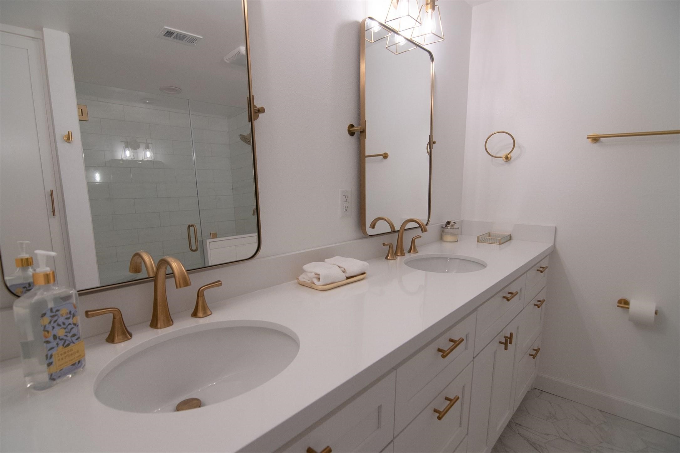 5534 Pagewood Lane Houston, TX 77056 - Photo 5 of 12 Master bathroom with double sinks, walk-in shower, and built in linen cabinet