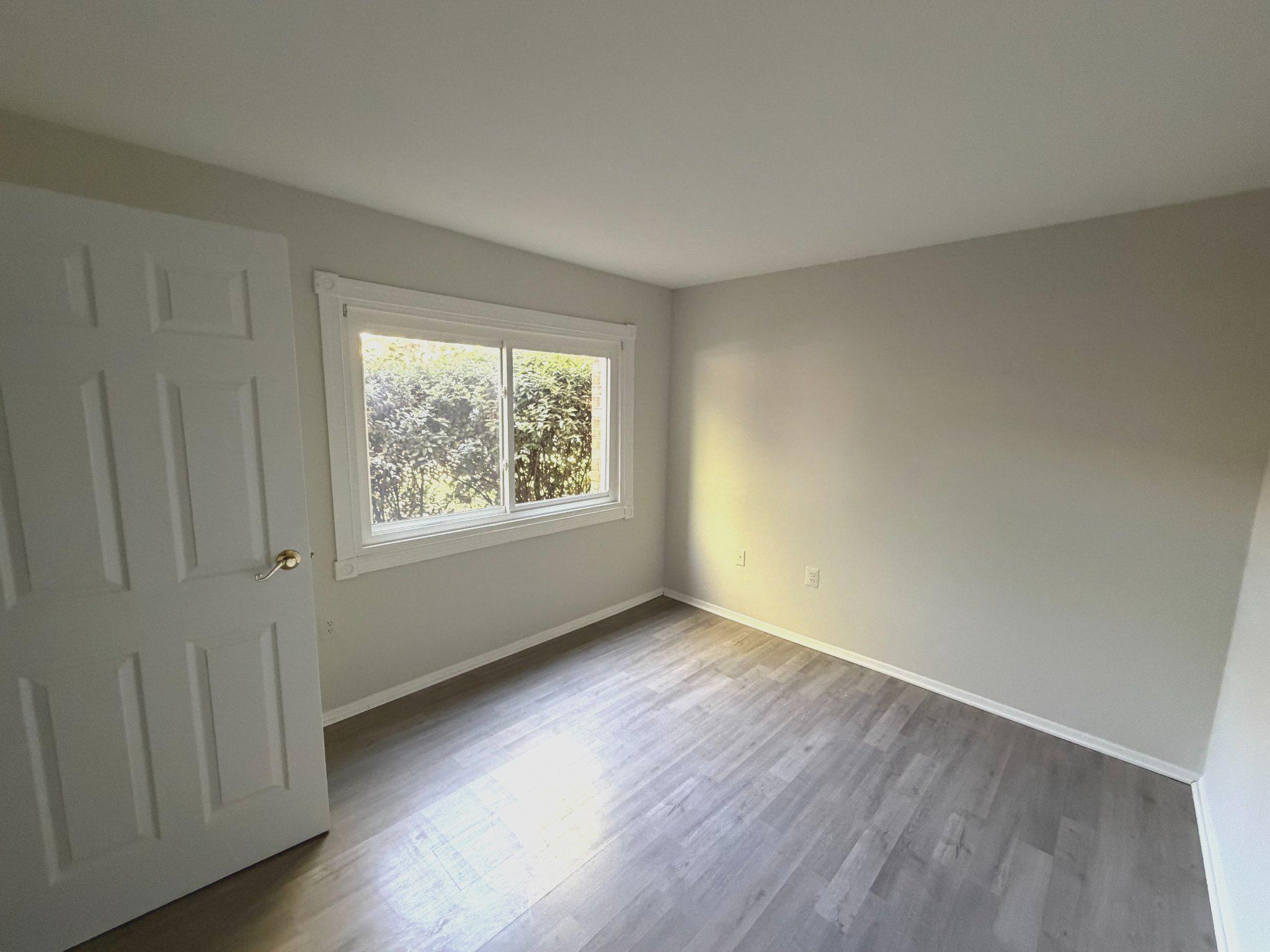 3732 Bel Pre Road, Unit 2 Silver Spring, MD 20906 - Photo 17 of 21 an empty room with wooden floor and windows
