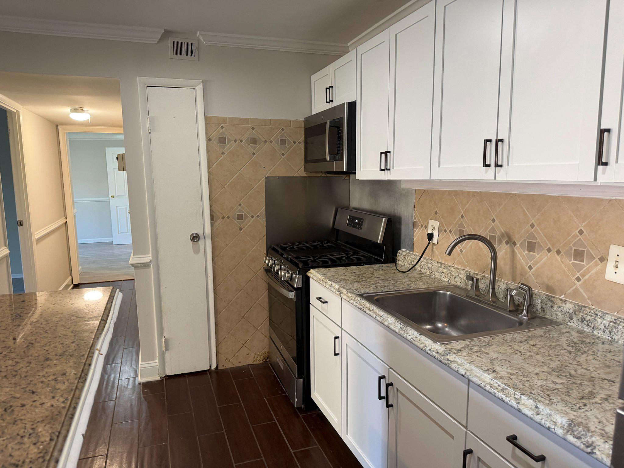3732 Bel Pre Road, Unit 2 Silver Spring, MD 20906 - Photo 6 of 21 a kitchen with stainless steel appliances granite countertop a sink stove and refrigerator
