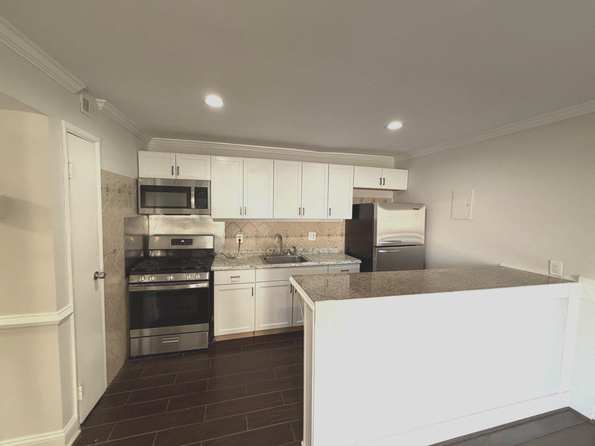 3732 Bel Pre Road, Unit 2 Silver Spring, MD 20906 - Photo 7 of 21 a kitchen with stainless steel appliances granite countertop a refrigerator a stove top oven a sink and dishwasher