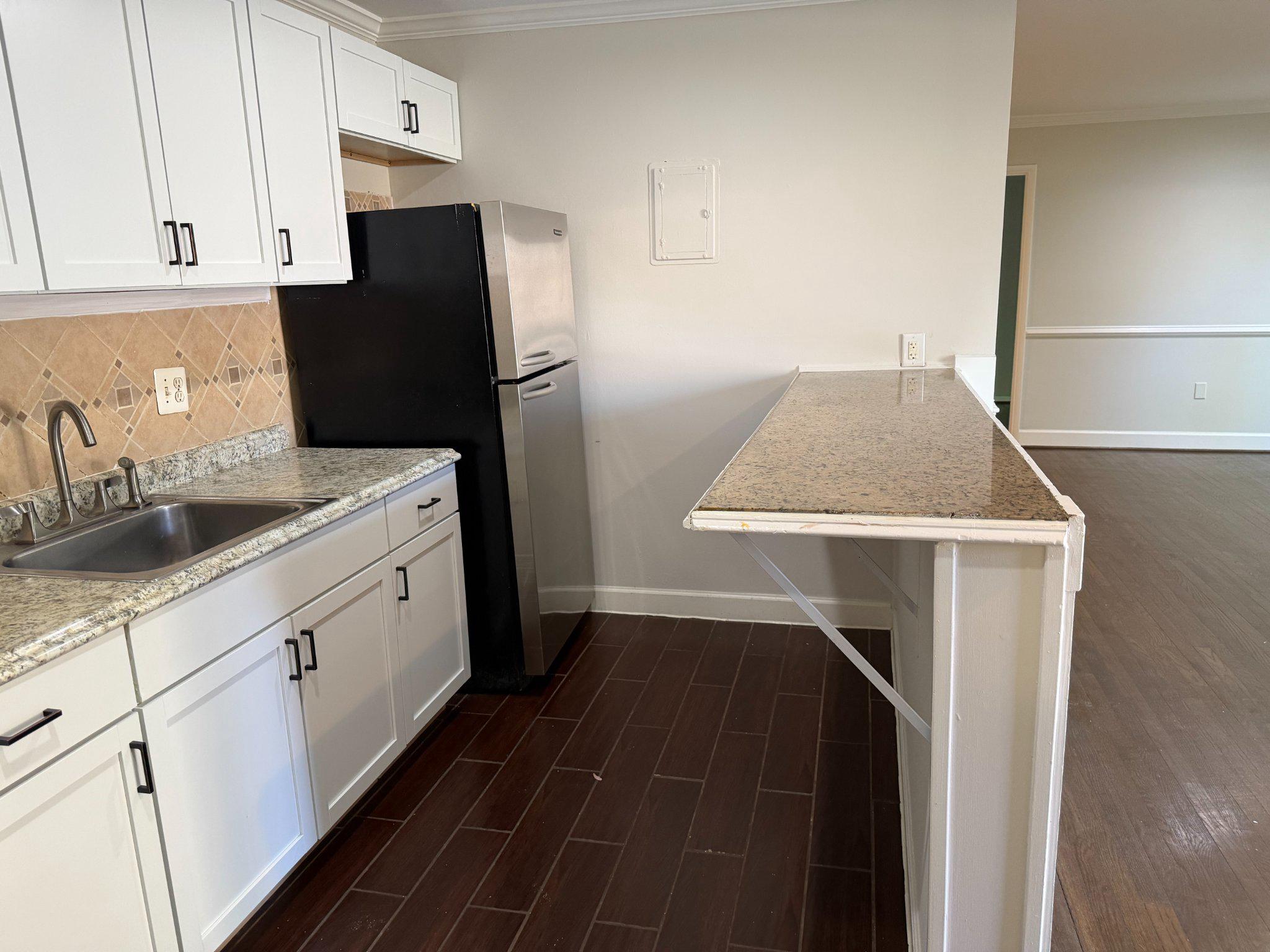 3732 Bel Pre Road, Unit 2 Silver Spring, MD 20906 - Photo 8 of 21 a kitchen with a sink a refrigerator and cabinets