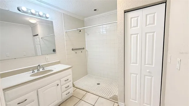 a bathroom with a shower sink double vanity and a mirror