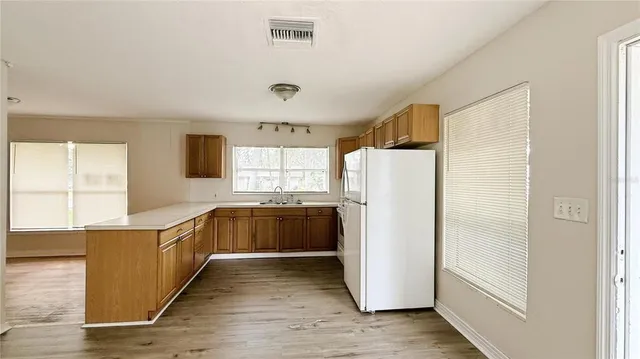 a kitchen with stainless steel appliances a refrigerator and a stove