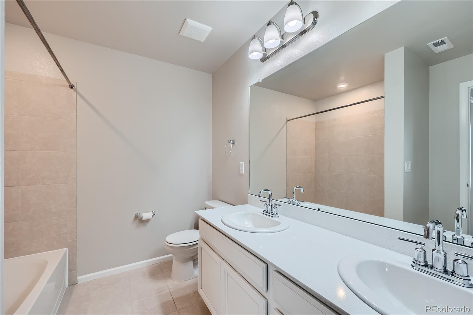 7199 Othello Street Castle Pines, CO 80108 - Photo 16 of 28 a bathroom with a sink a toilet and a mirror