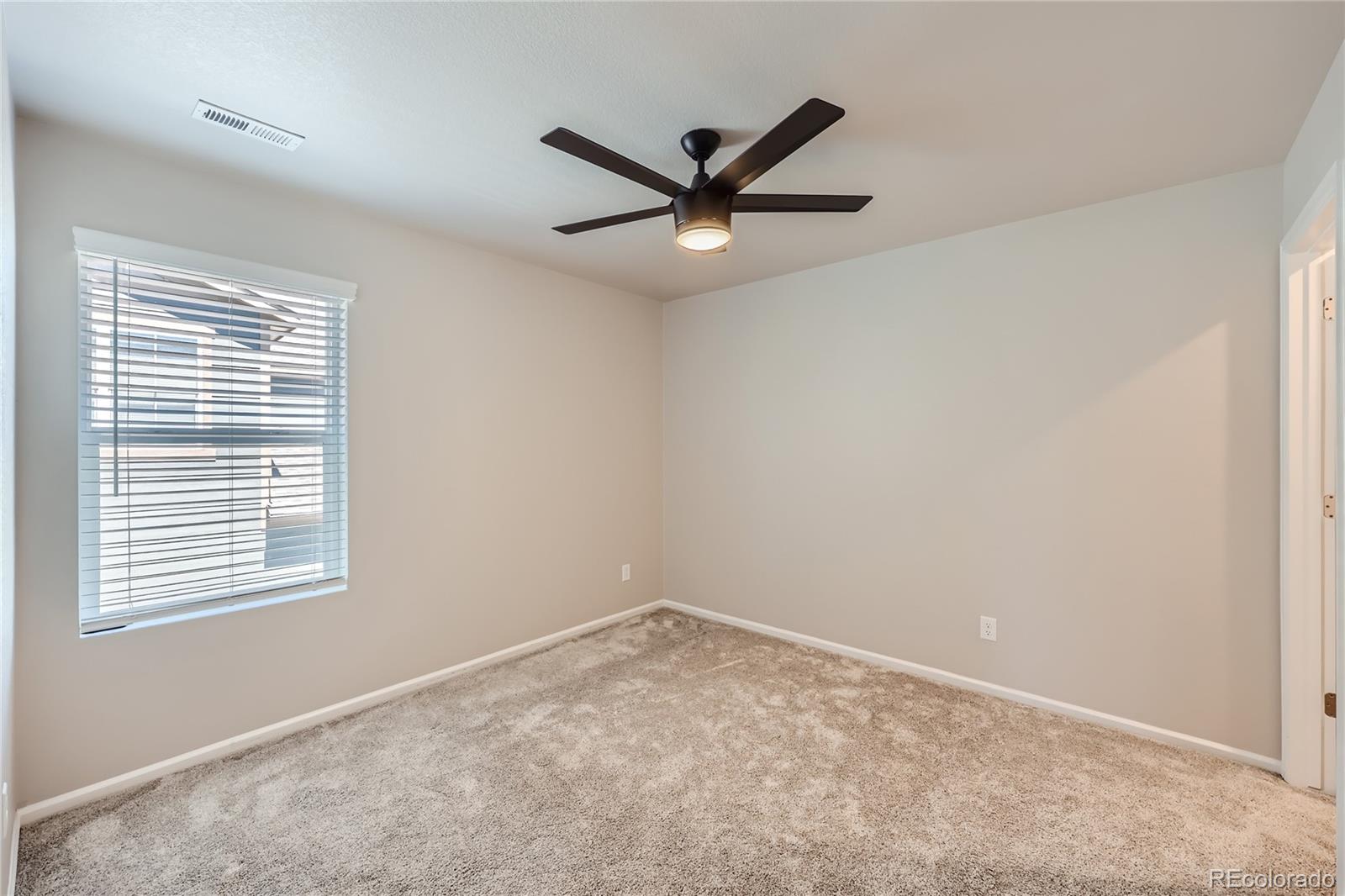 7199 Othello Street Castle Pines, CO 80108 - Photo 18 of 28 a view of an empty room with a window
