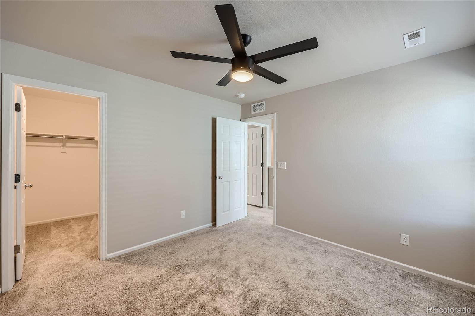 7199 Othello Street Castle Pines, CO 80108 - Photo 20 of 28 a view of a livingroom with a ceiling fan and window