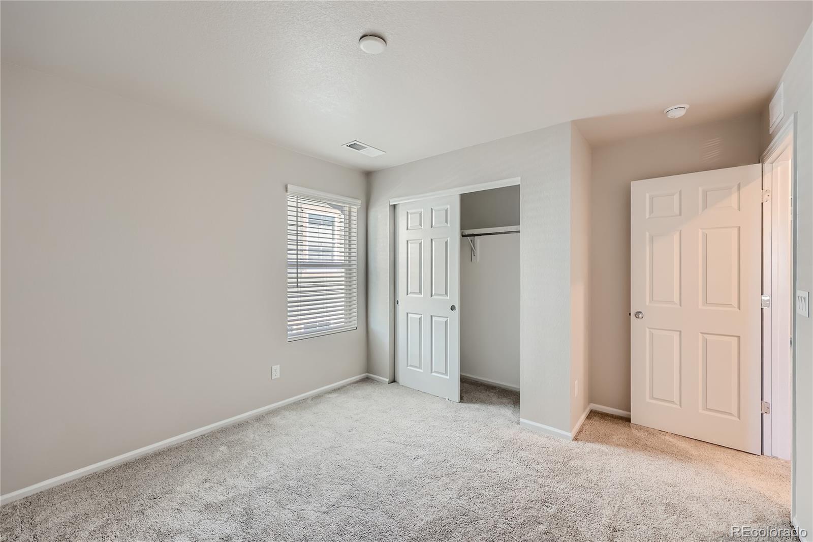 7199 Othello Street Castle Pines, CO 80108 - Photo 21 of 28 an empty room with windows and closet