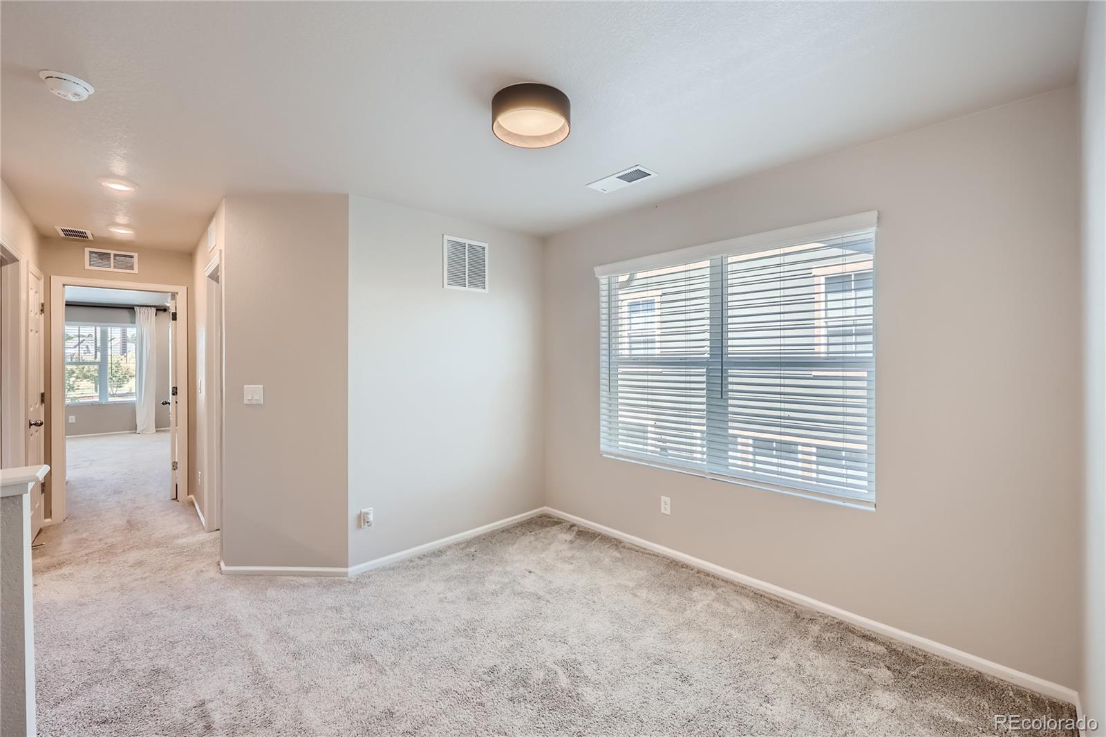 7199 Othello Street Castle Pines, CO 80108 - Photo 22 of 28 a view of an empty room with a window