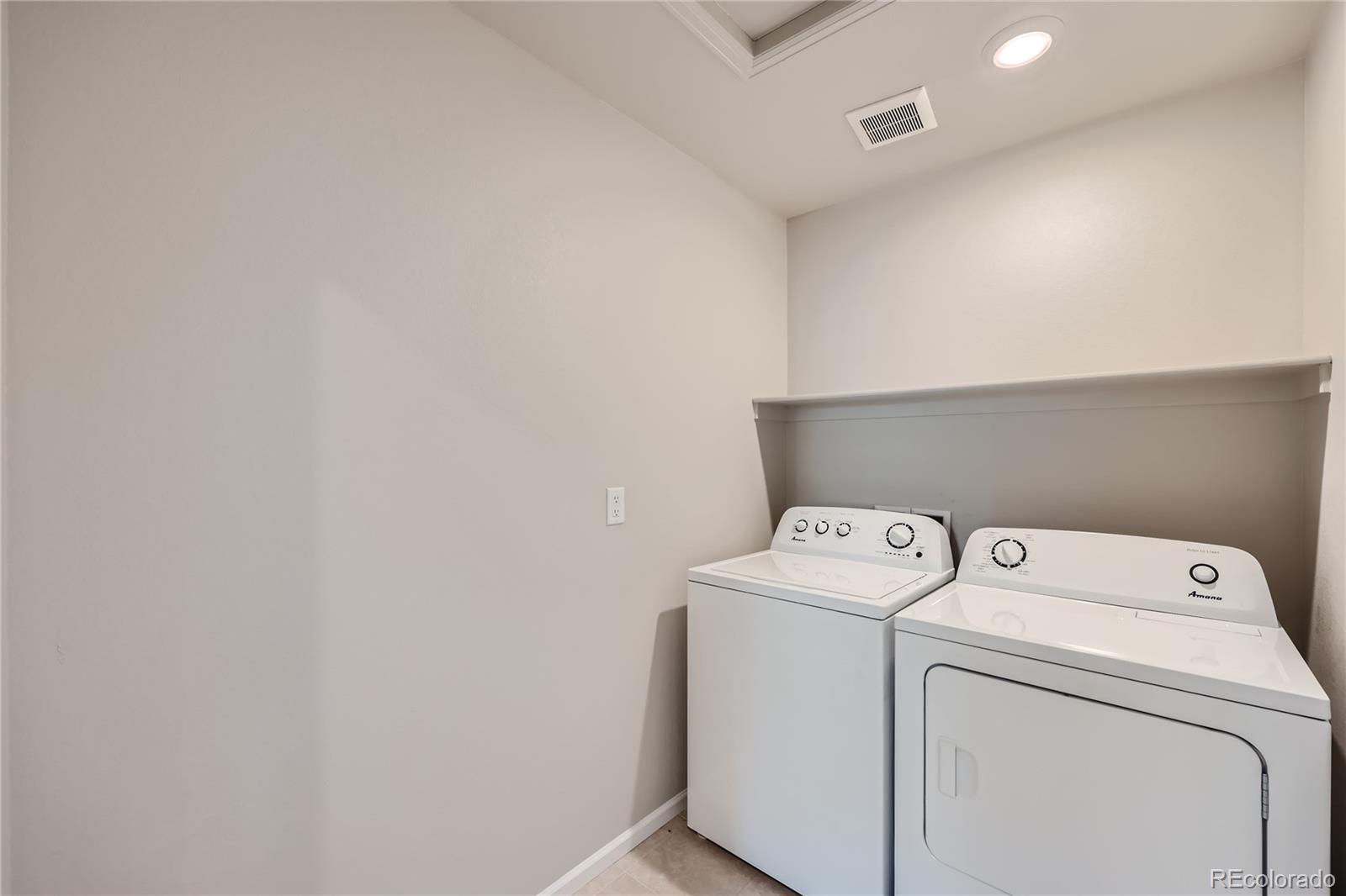 7199 Othello Street Castle Pines, CO 80108 - Photo 24 of 28 a utility room with dryer and washer