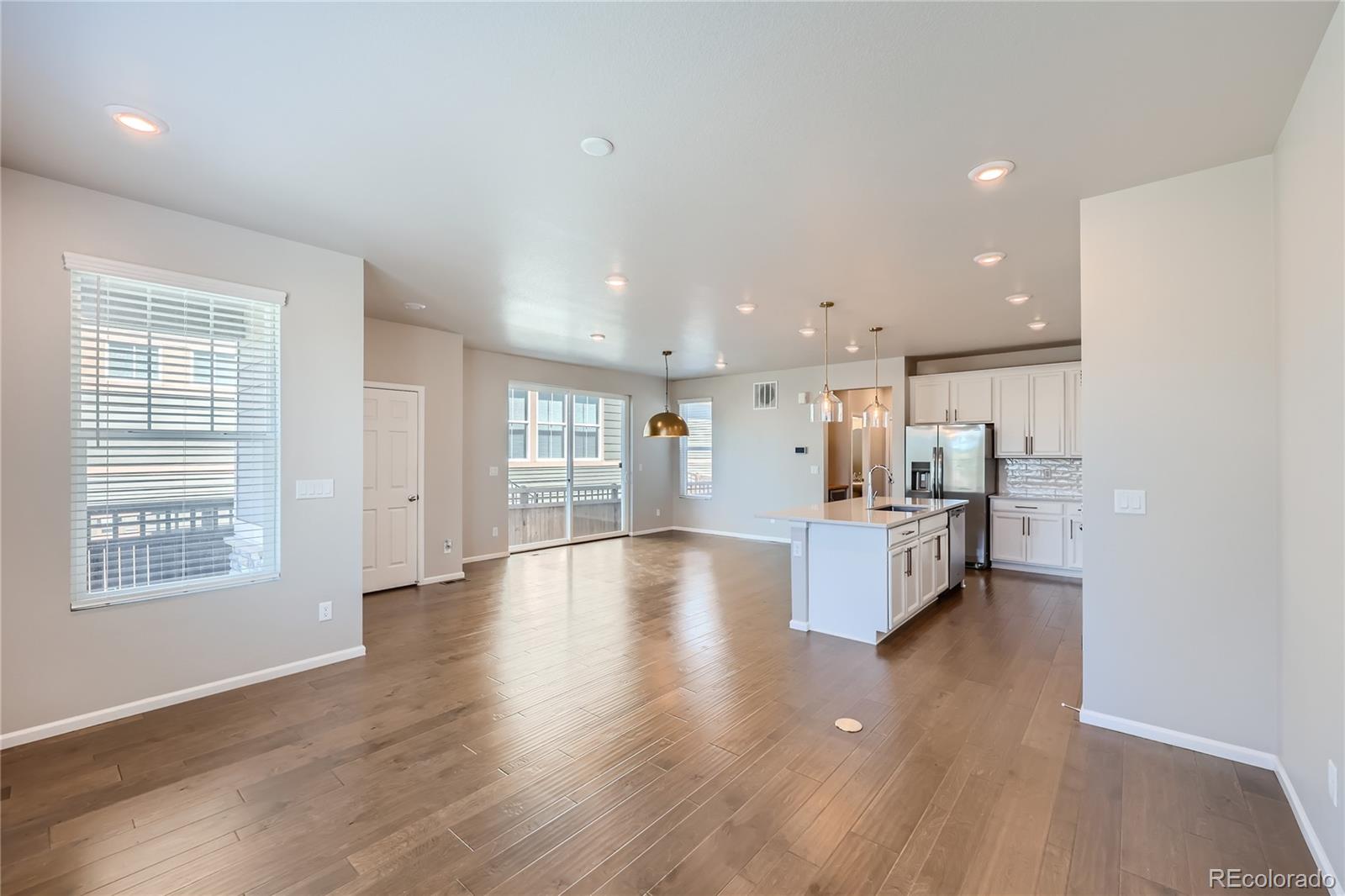 7199 Othello Street Castle Pines, CO 80108 - Photo 7 of 28 a large space with kitchen island in center