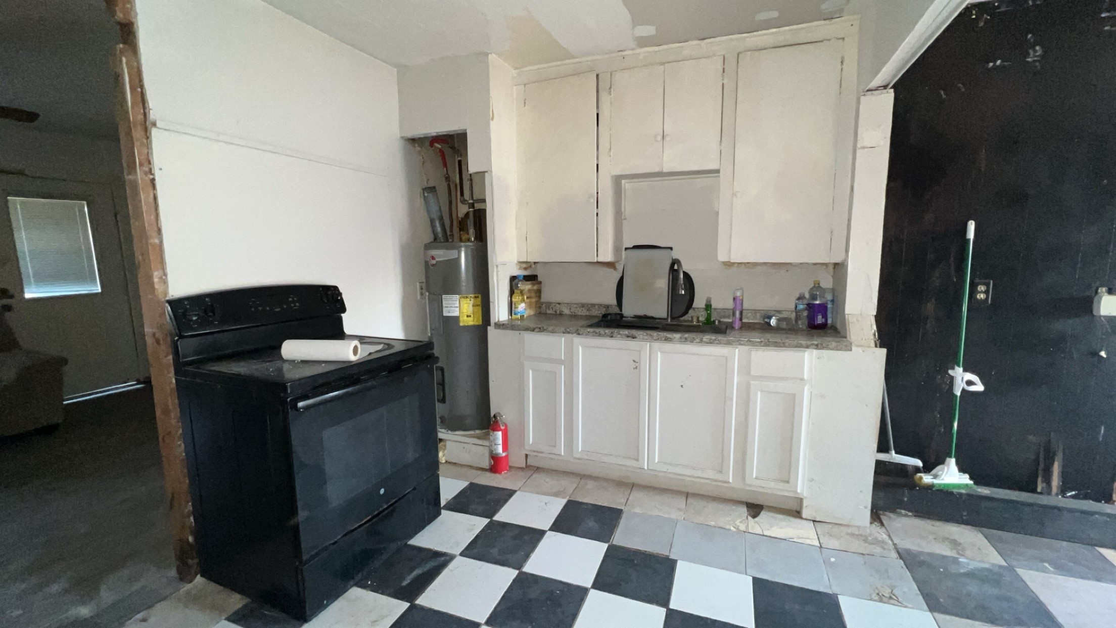 1301 Hempstead Street Pasadena, TX 77506 - Photo 3 of 12 a kitchen with a sink a refrigerator and cabinets