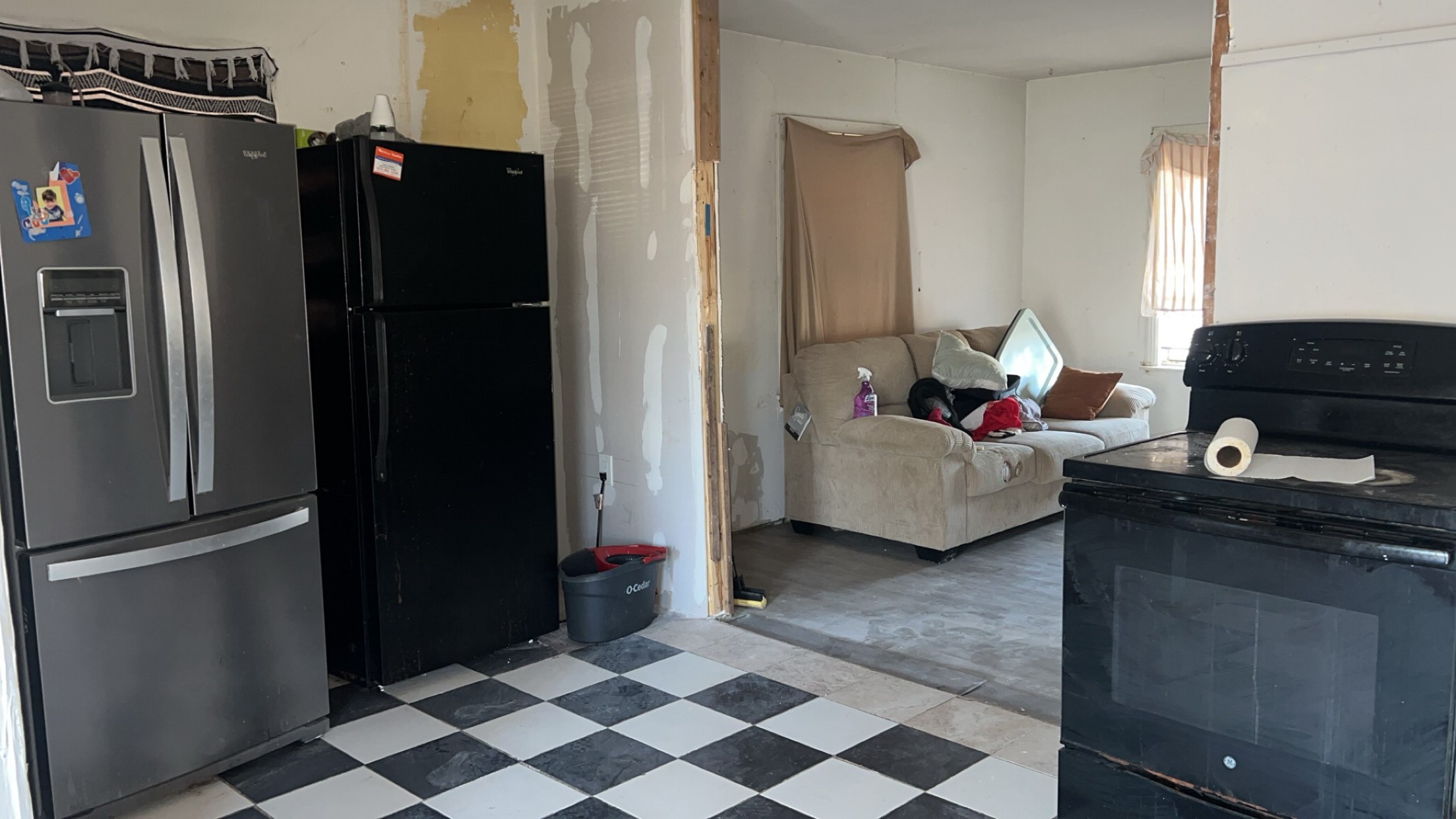 1301 Hempstead Street Pasadena, TX 77506 - Photo 4 of 12 a living room with furniture and a refrigerator
