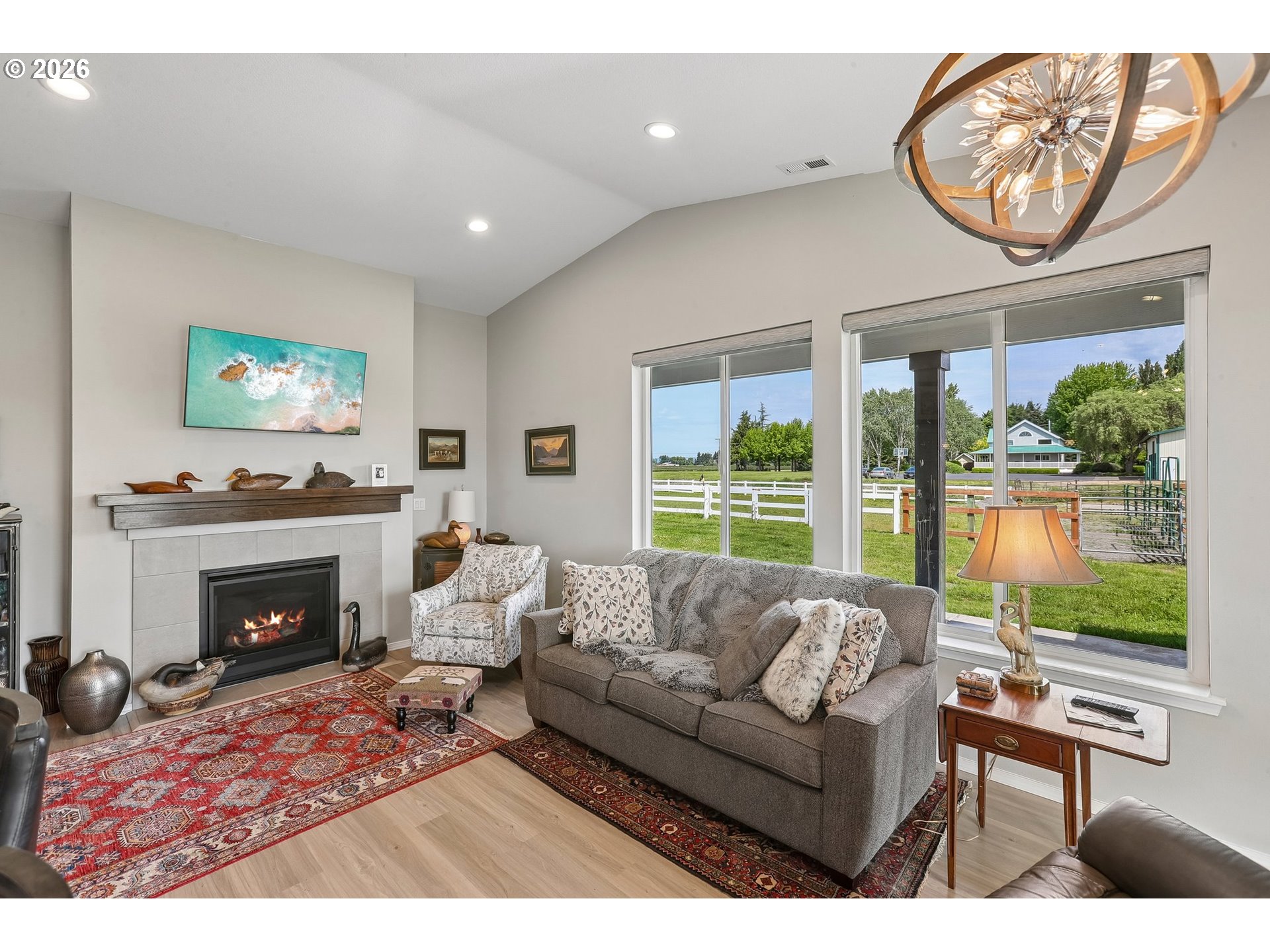 298 Roberson Road Woodland, WA 98674 - Photo 32 of 48 a living room with furniture a large window and a fireplace